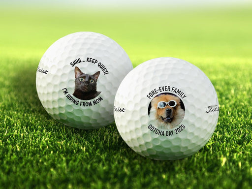 Titleist golf balls are shown on a patch of grass. Both golf balls feature different custom photos and text.