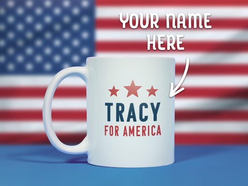 text says Your Name Here, image features white mug with red white and blue American design with typography that says Tracy for America with Red Stars sitting on a blue surface with an American flag backdrop