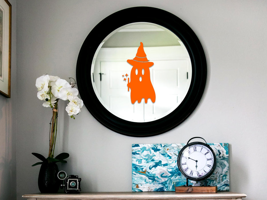 Ghost Witch sticker (in orange) is shown stuck to a mirror.