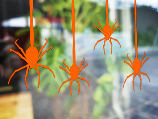 Hanging Spider sticker (in orange) is shown stuck to the exterior of a window.