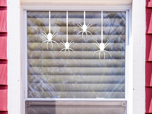 Hanging Spider sticker (in white) is shown stuck to the exterior of a window.