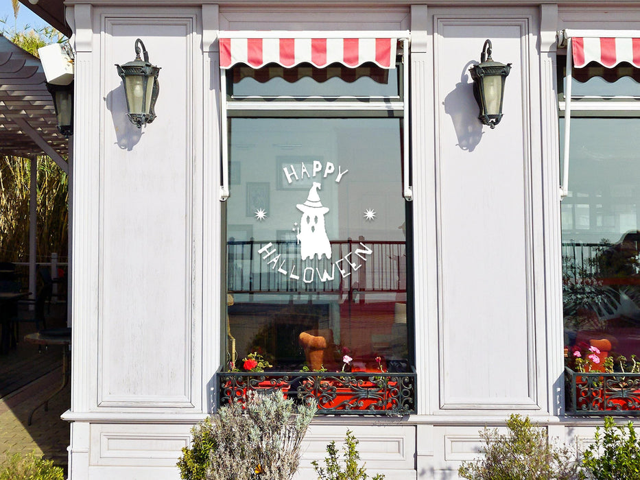 Happy Halloween Ghost sticker (in white) is shown stuck to the exterior of a storefront window.