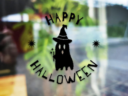 Happy Halloween Ghost sticker (in black) is shown stuck to the exterior of a window.