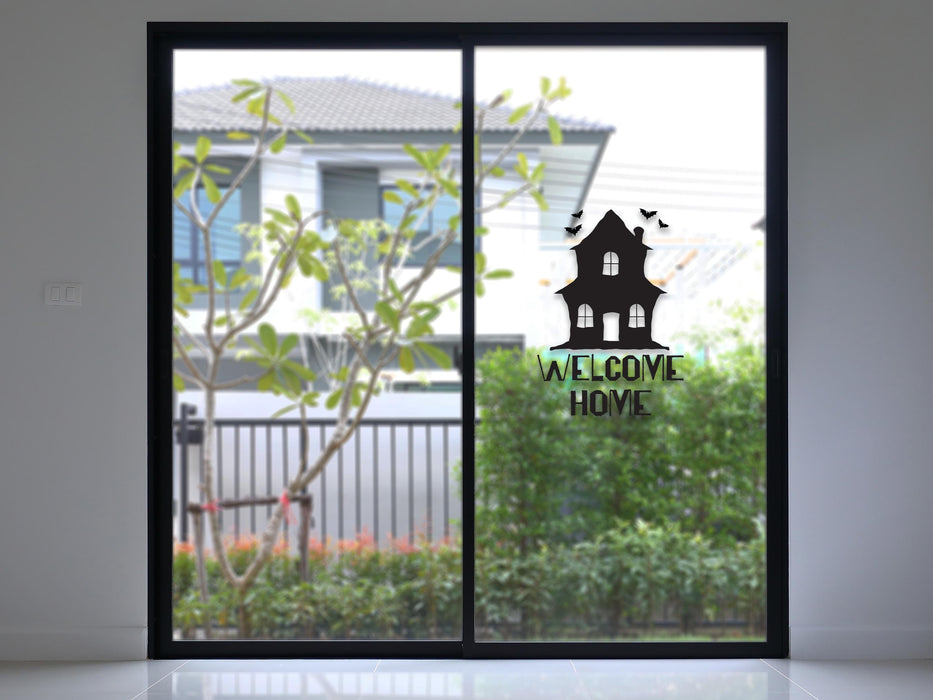 Haunted Welcome Home sticker (in black) is shown stuck to the interior of a window.