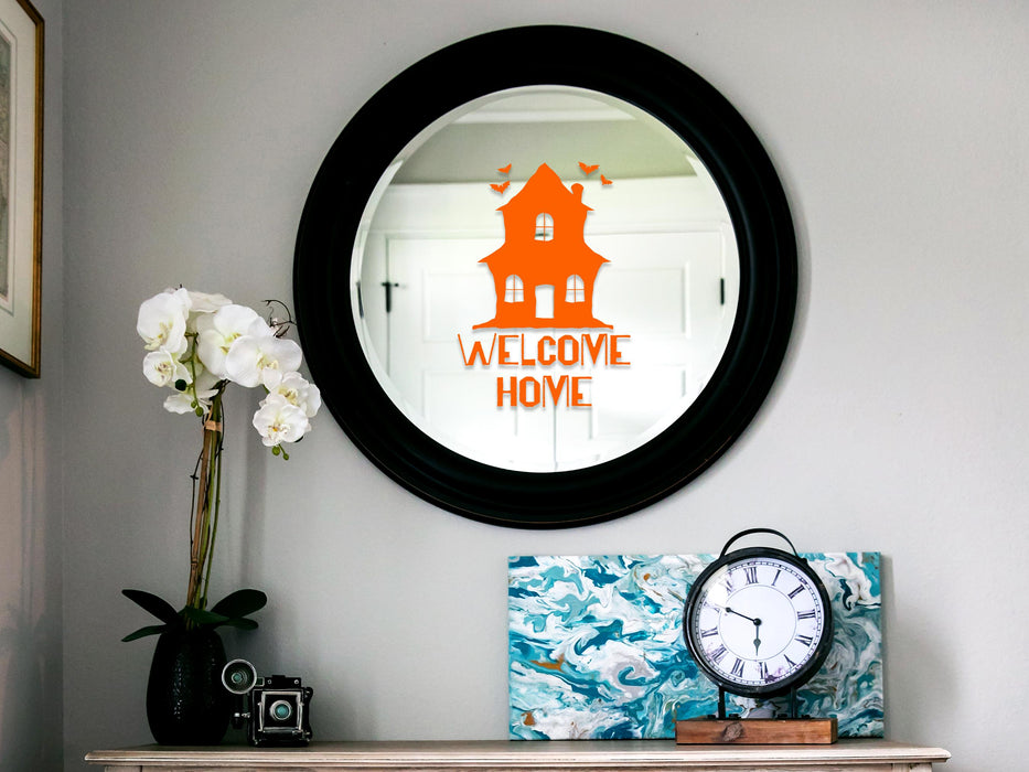 Haunted Welcome Home sticker (in orange) is shown stuck to a mirror.