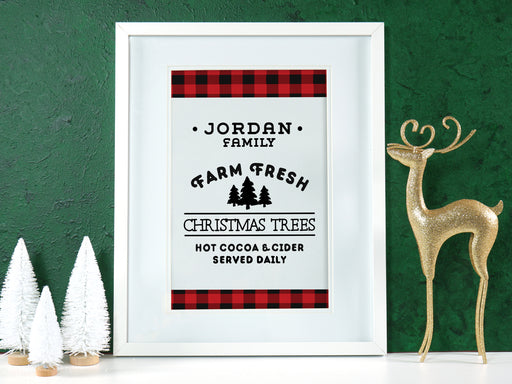 Farm Fresh Christmas Trees design shown as digital download. Design has red and black plaid border with the black text, Jordan Family Farm Fresh Christmas Trees Hot Cocoa & Cider Served Daily. Design is shown in a white picture frame.