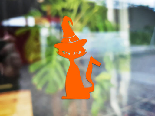 Witch Cat sticker (in orange) is shown stuck to the exterior of a window.