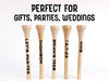 Multiple personalized, engraved golf tees are shown on a white background with the words perfect for gifts, parties, weddings