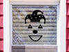 Jester sticker (in black) is shown stuck to the exterior of a window.