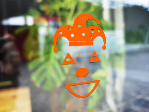 Jester sticker (in orange) is shown stuck to the exterior of a window.