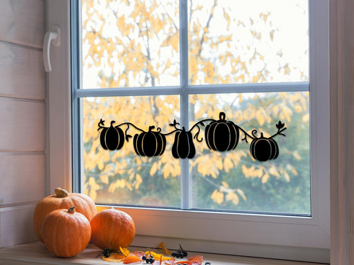 Pumpkin Patch sticker (in black) is shown stuck to the interior of a window.