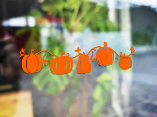 Pumpkin Patch sticker (in orange) is shown stuck to the exterior of a window.