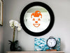 Jester sticker (in orange) is shown stuck to a mirror.