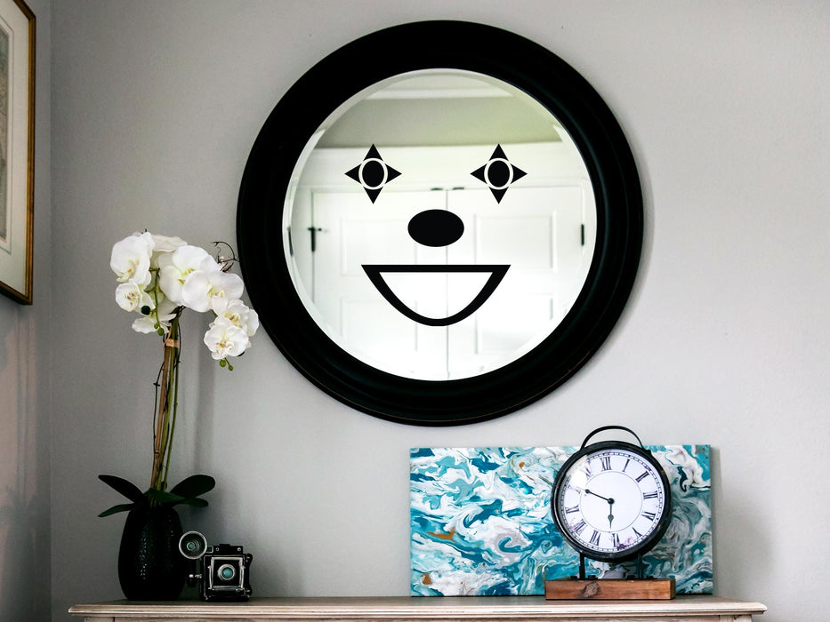 Clown sticker (in black) is shown stuck to a mirror.