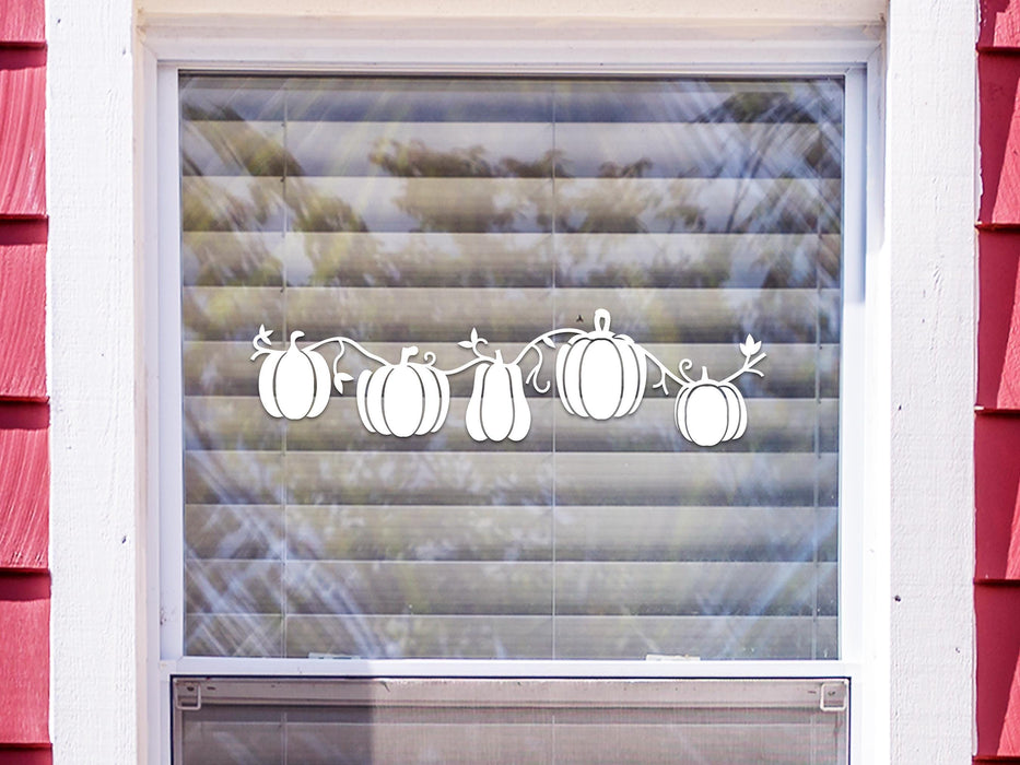 Pumpkin Patch sticker (in white) is shown stuck to the exterior of a window.