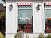 Pumpkin Patch sticker (in white and orange) is shown stuck to the exterior of a storefront window.