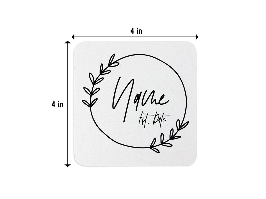 Single coaster with size measurements. Coasters feature Floral Family Name design. Design has a simple, circular, floral frame around the words "Name Est. Date". Design is printed on a white square coaster. Coaster is sized to 4 inch width and 4 inch height.