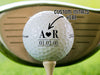 golf ball on a golf tee with an initial and heart design, text says custom initials here with a golf club in the background