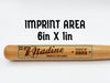 wooden mini baseball bat with custom laser engraved design that features a name with a baseball with a number and says "#7 Nadine, Nanakuli Lady Hawks, class of 2023" on a white surface with the words imprint area on it