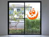 orange goofy pumpkin face on glass door