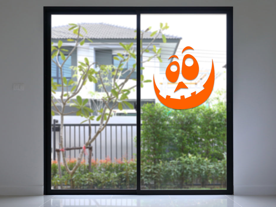 orange goofy pumpkin face on glass door