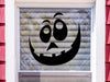 black goofy pumpkin face on an outdoor window