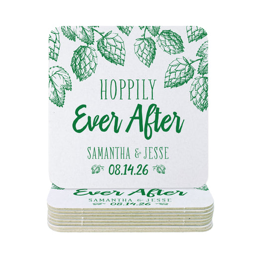 A stack of coasters with a single coaster on top shown on a white background. Coasters feature Hoppily Ever After design. This design uses green lettering and sketched drawings of beer hops. Wedding couples names and date can be customized.