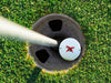 golf ball in a golf course hole that says imagine this is Kim with a red x on it