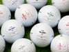 multiple golf balls with various colors of printed lost by fill in designs 