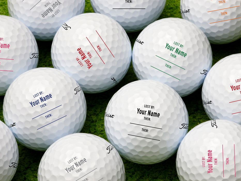 multiple golf balls with various colors of printed lost by fill in designs 