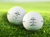 two golf balls on golf course grass with lost by fill in name designs