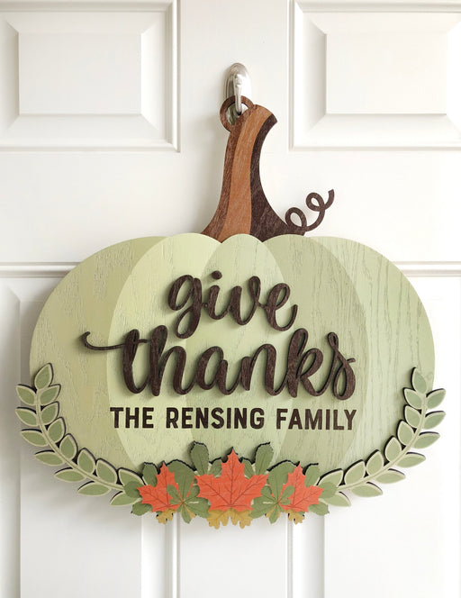 personalized give thanks door sign that says The Rensing Family hanging on a door