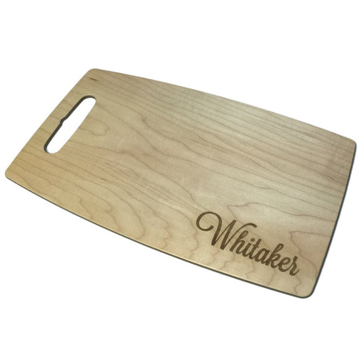 personalized engraved cutting board with the name Whitaker on it