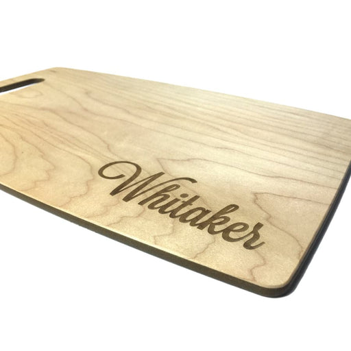 personalized engraved cutting board with the name Whitaker on it