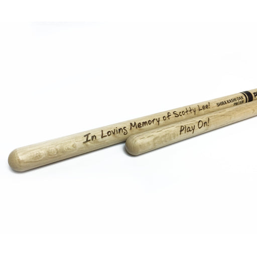 laser engraved wooden drum sticks that say In Loving Memory of Scotty Lee! Play On!