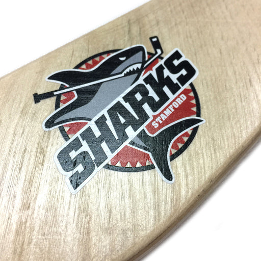 close up of wooden hockey stick with printed sharks logo on it