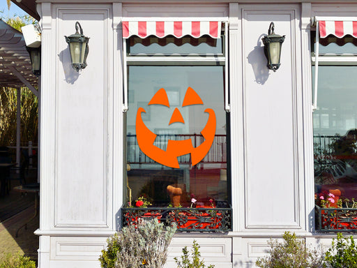 Smiley  pumpkin face vinyl sticker placed on shop exterior window