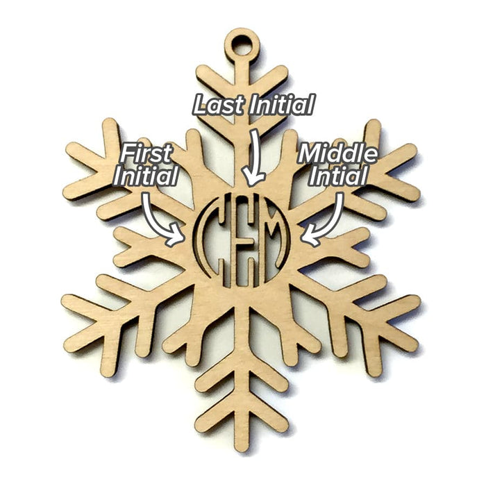 Ornament shown with monogram letter placement. Letter placement: First name initial, last name initial, middle name initial. Snowflake Monogram ornament design is featured. The letters CEM can be seen as a monogram in the center of ornament. Ornament is made of birch wood and laser cut.