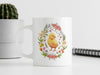 a white coffee mug with a yellow chick on it