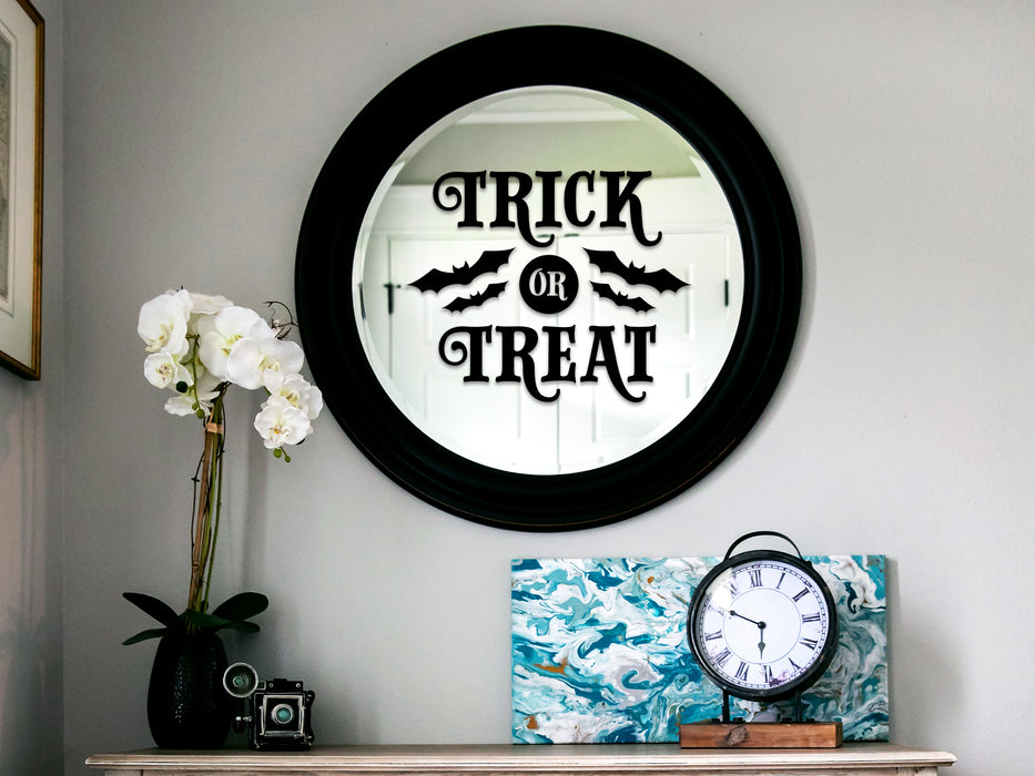 black trick or treat vinyl sticker on living room mirror over a countertop 