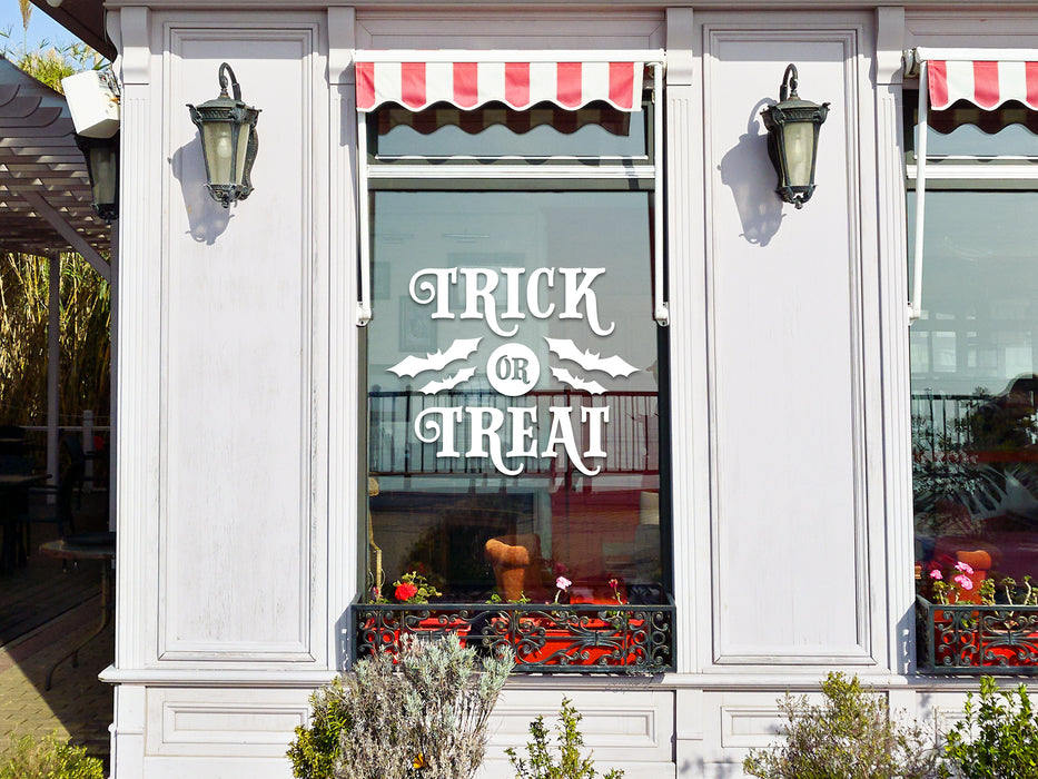 white trick or treat vinyl sticker on exterior shop window