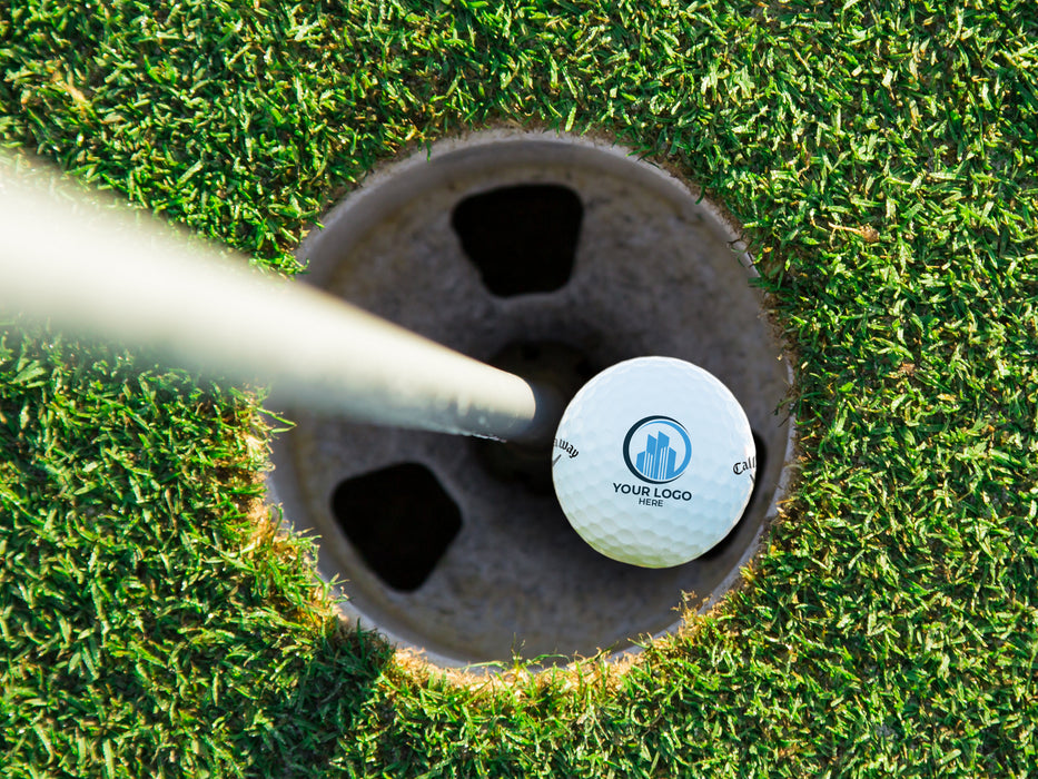 golf ball in a course hole with a logo printed on it